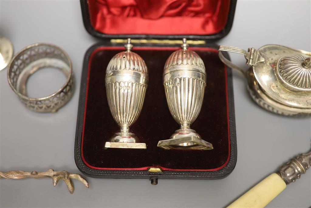 A cased pair of Victorian silver peppers, Sheffield, 1891, 79mm, five other silver condiments, etc.